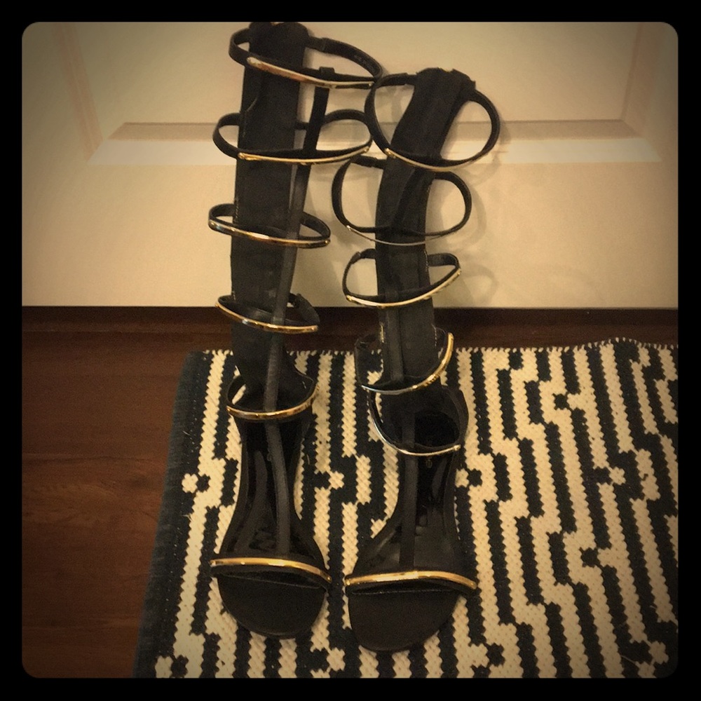 Bebe Black and Gold Gladiator Sandals.